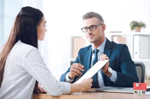 A woman meeting with a lawyer to discuss filing a Phoenix Essure lawsuit.