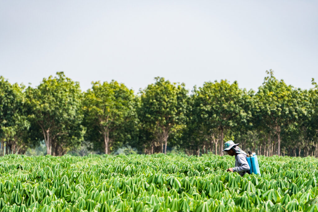 Man spraying a field with chemicals starting Atlanta Paraquat Lawsuit.