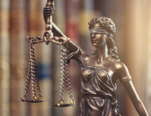 class action lawsuits concept image, a statute of blindfolded lady justice