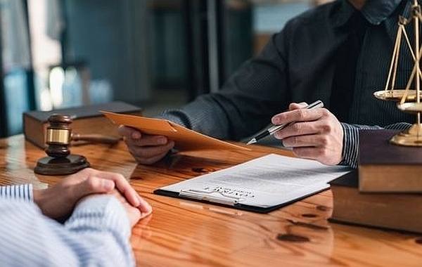An attorney helping a client join a class action lawsuit
